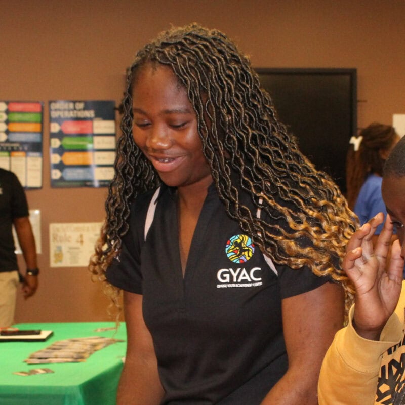 Students speak with local, minority owned businesses at GYAC's YEP Rally in celebration of Juneteenth.