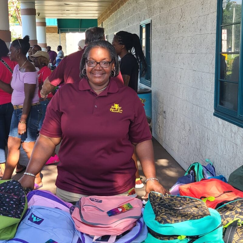 Tabitha Williams from Gifford Youth Orchestra volunteers at GYAC's Back to School Giveaway