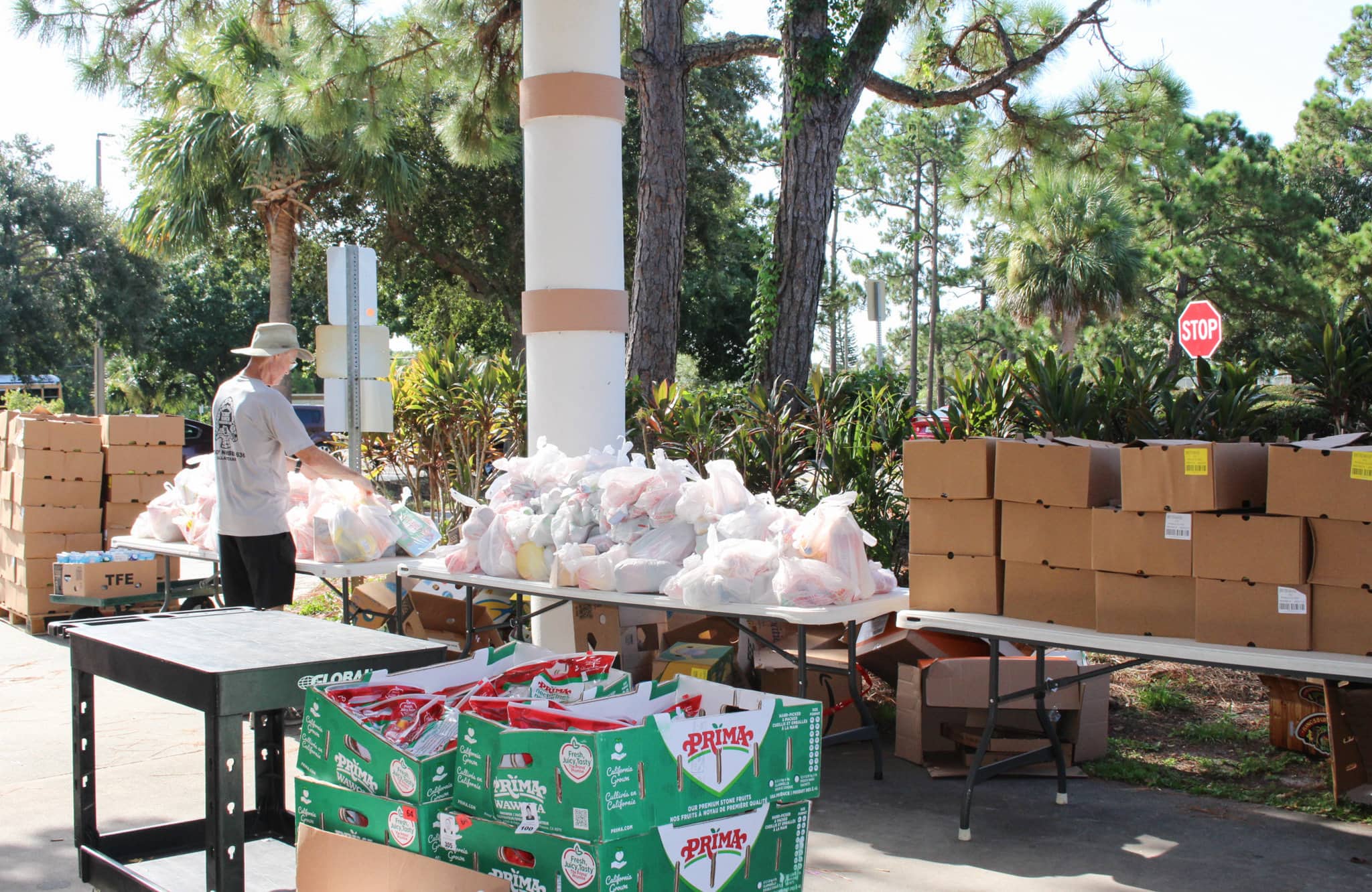 Volunteer places food items in plastic bag at GYAC's Mobile Food Pantry