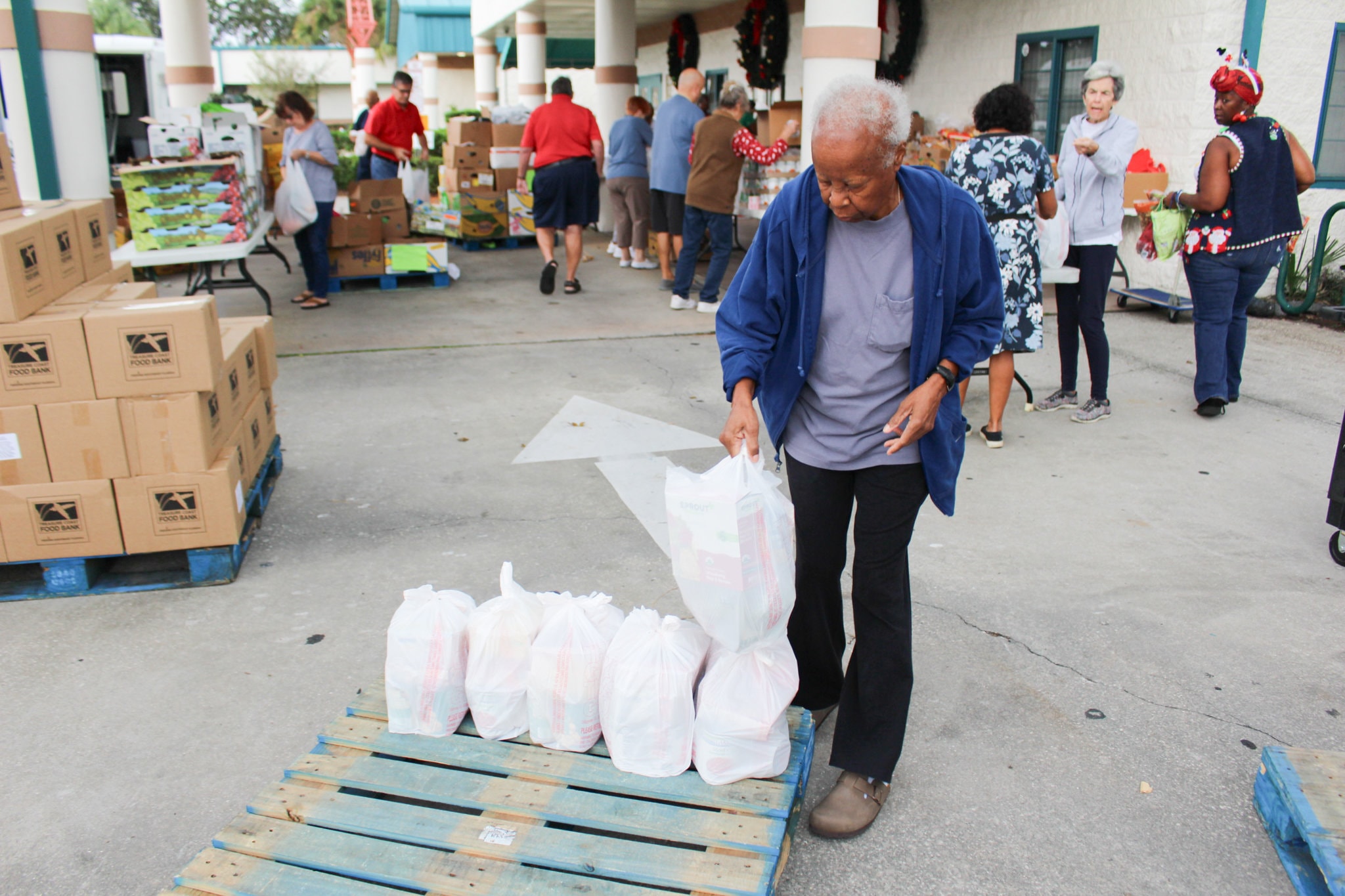 GYAC's Mobile Food Pantry volunteer gathers bags for food distribution on December 13, 2023.